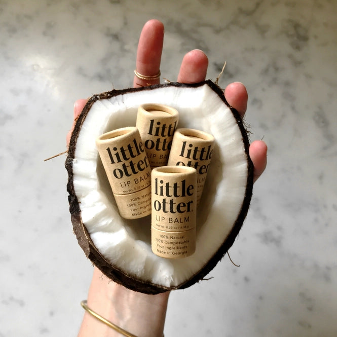 Four lip balms inside a coconut
