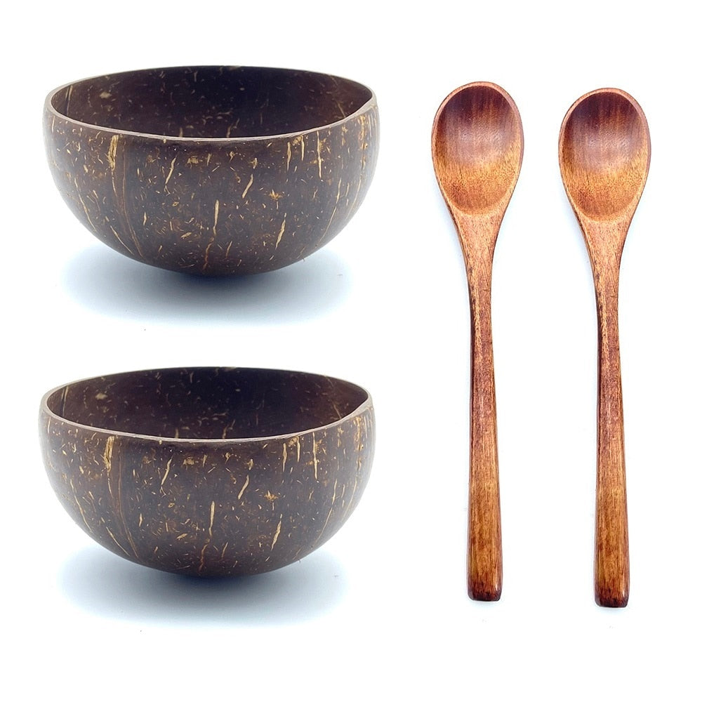 two coconut bowls with two wood spoons