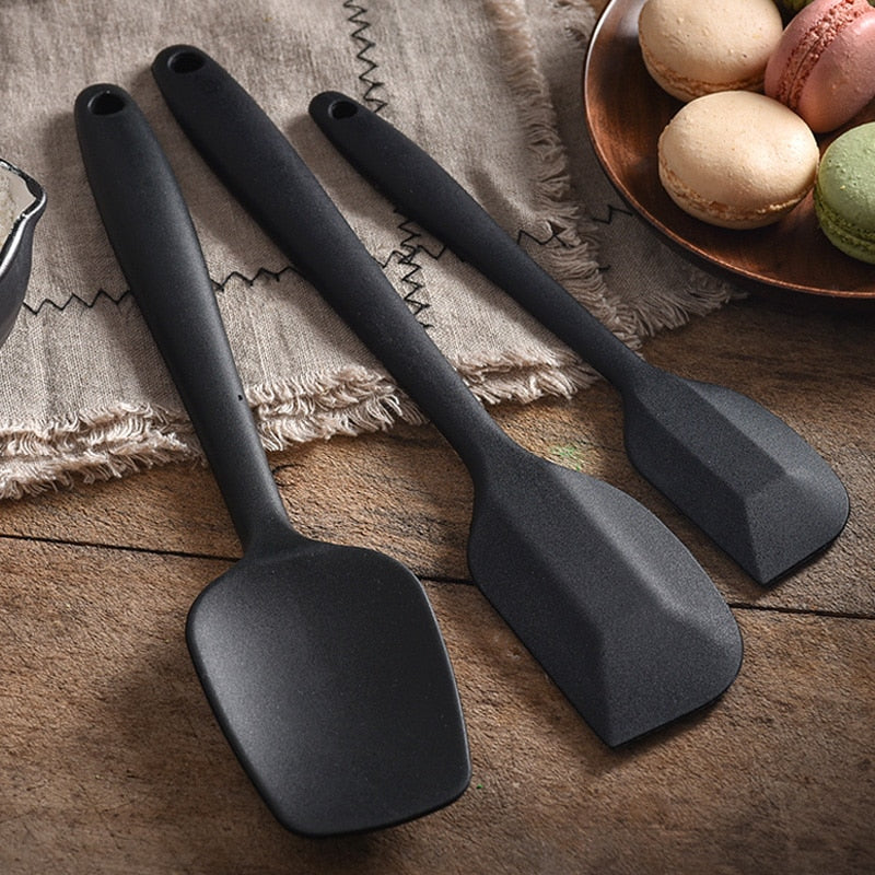 set of black spatulas on counter