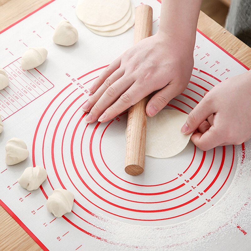 rolling dough on red baking mat