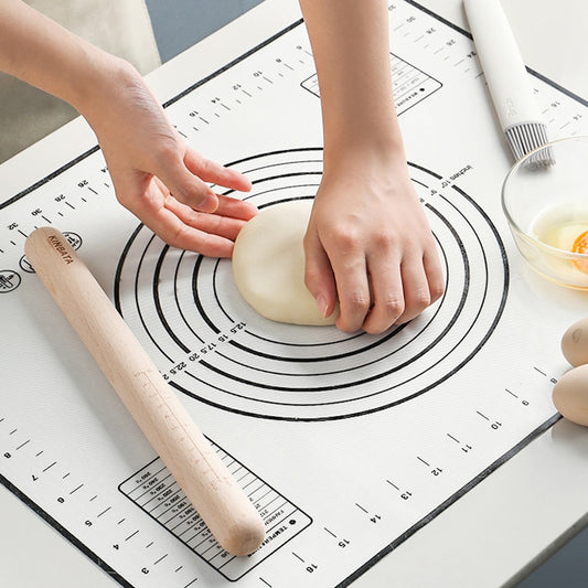 shaping dough on black baking mat 