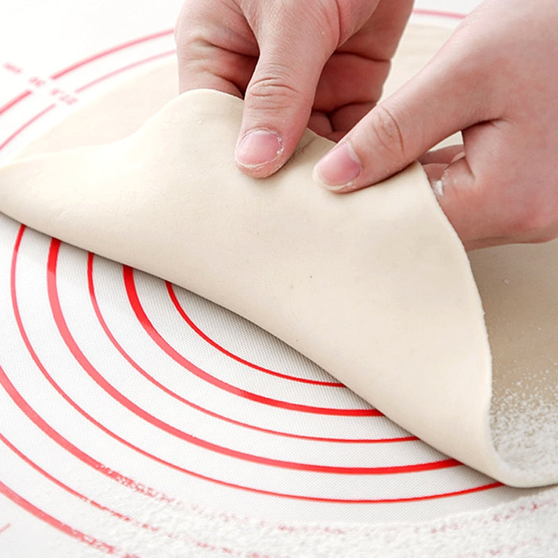 shaping dough on red baking mat