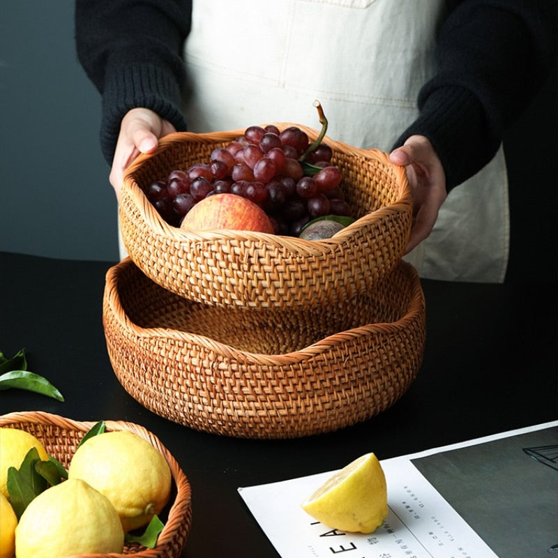 two round rattan storage baskets with fruit