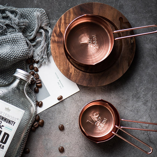 copper measuring cups on counter